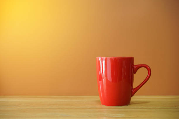 istock Red coffee cup on wooden desk with brown background 1305820261