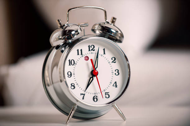 istock Alarm clock on the Night Table in the bedroom 1305820291