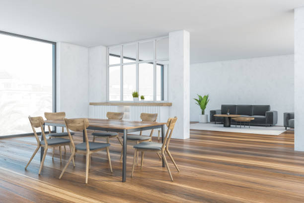 istock White and wooden living room with chairs and table, sofa and window 1305820621