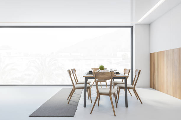 istock White and wooden dining room with chairs and table near window 1305820681