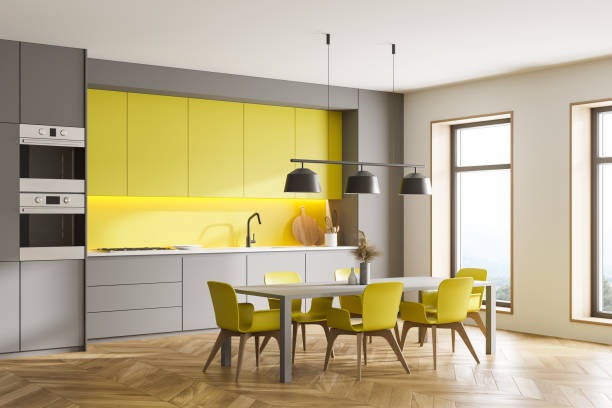 istock Gray and yellow kitchen corner with table and windows 1305822819