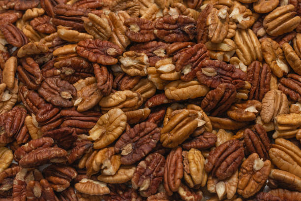 istock Tasty pecan-nut background. Top view. 1305823110