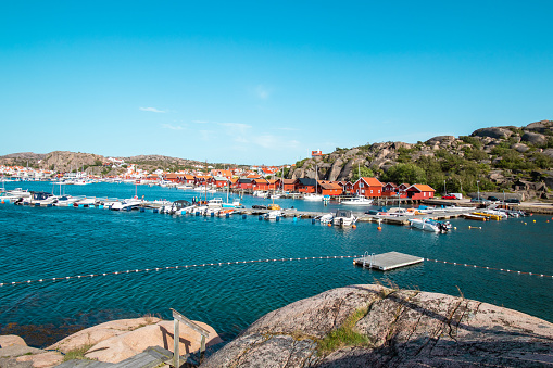 Red houses and white boats in a bay in Sweden III