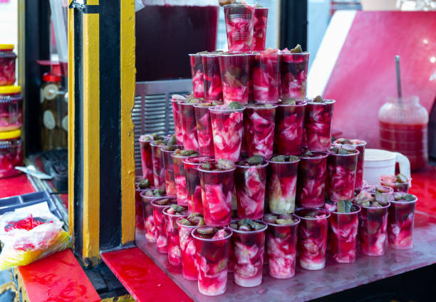 Traditional Turkish pickled vegetables in sour brine Tursu suyu in street market Traditional Turkish Torshi (Tursu suyu), pickled vegetables in sour brine from turnip in plastic cups for sale in street market pickled turnip stock pictures, royalty-free photos & images