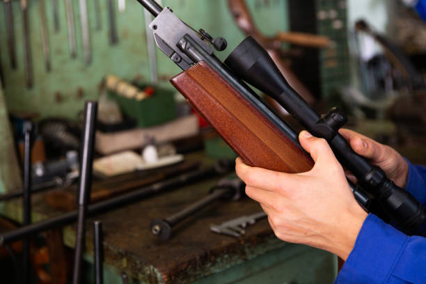 istock Gunsmith hands installing optical sight on single-barreled rifle 1305824616