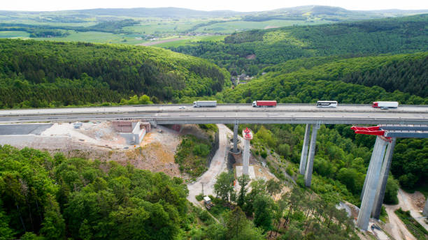 istock Highway bridge under construction - aerial view 1305827815