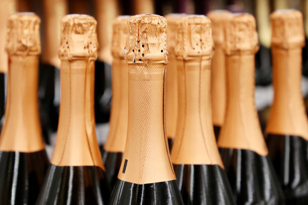 istock Sparkling wine bottles in golden foil for celebration 1305829214
