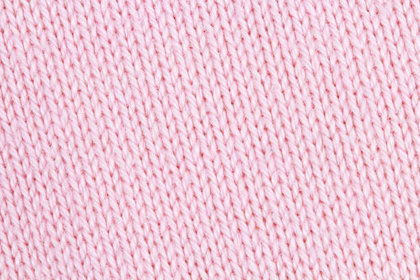 istock Texture of pink knitted fabric as background 1305829312