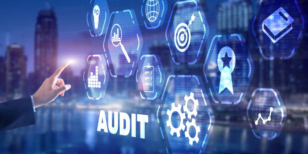 istock Businessman is selecting Audit on the virtual screen on city background 1305829360