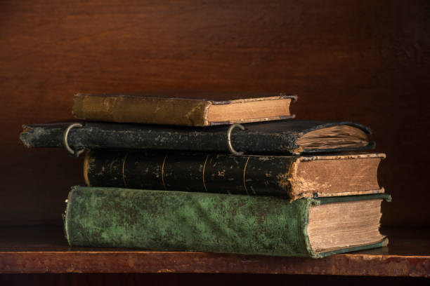 istock Antique Books Stacked on a Shelf 1305831118