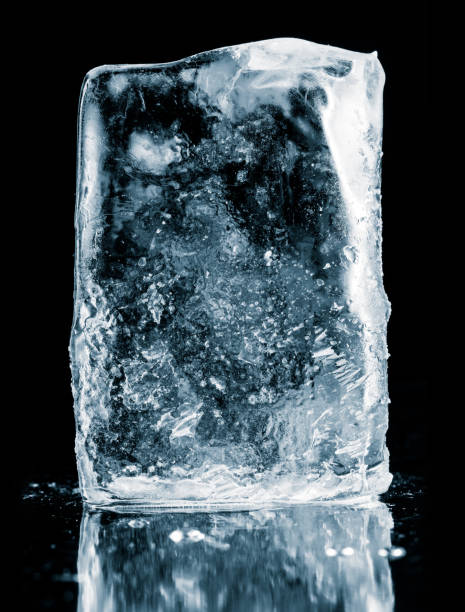istock Crystal clear natural ice block on a black reflective surface. Clipping path included. 1305831289