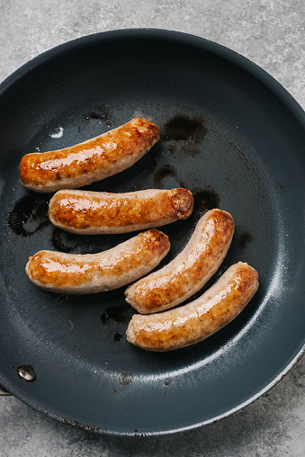 Overhead view of sausage links in a frying pan in Frederick, MD, United States