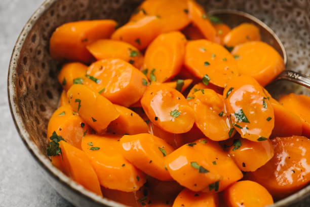 istock Glazed carrots in a bowl ready to be served 1305831715