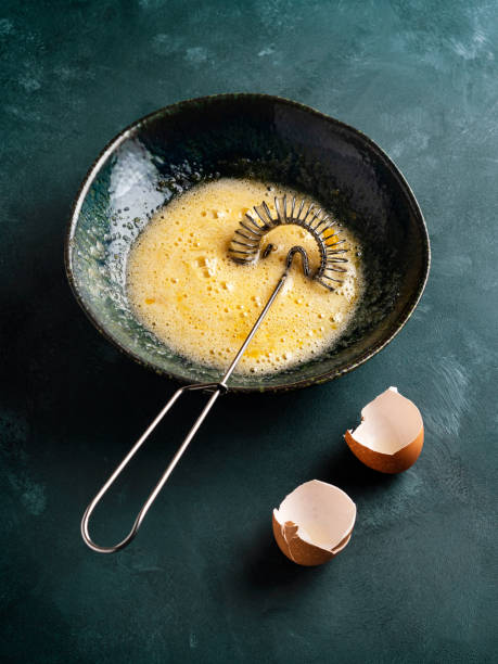 istock Mixing egg with sugar, Whisking egg with sugar,  Whipped eggs and sugar, Egg yolk is whipped 1305832705