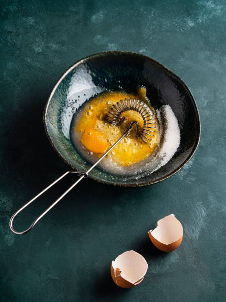 istock Mixing egg with sugar, Whisking egg with sugar,  Whipped eggs and sugar, Egg yolk is whipped 1305833038
