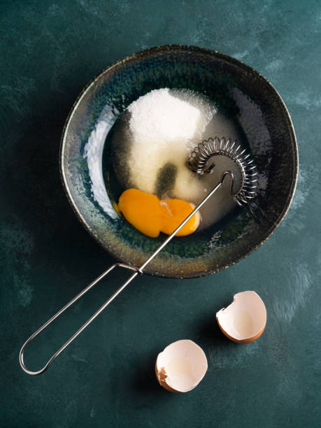 istock Mixing egg with sugar, Whisking egg with sugar,  Whipped eggs and sugar, Egg yolk is whipped 1305833149