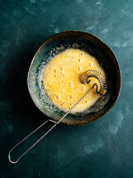 istock Mixing egg with sugar, Whisking egg with sugar,  Whipped eggs and sugar, Egg yolk is whipped 1305833311