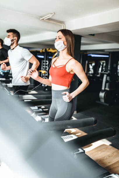 istock Young people wearing face mask in the gym 1305834320