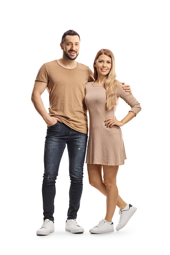 Full length portrait of a young couple posing isolated on white background