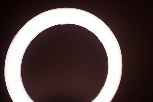 istock Large LED ring light in a studio room against empty walls front view. 1305835179