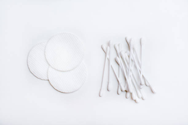 istock Several clean cotton pads and cotton swabs on a white background. Top view 1305837193