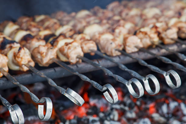 Pork kebabs are cooked on the grill. Dishes for a picnic in nature. Traditional national dishes. Delicious photos of homemade food.