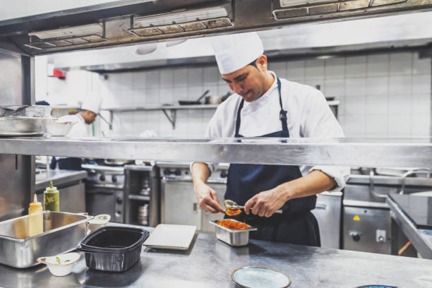 istock Chef platting Indian desert at the restaurant kitchen 1305838152