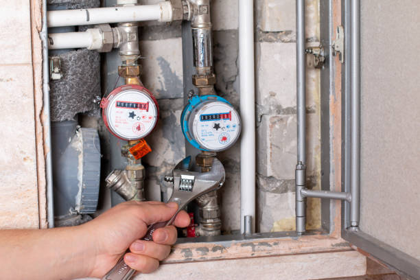 istock Plumber's hands with wrench while repairing pipes 1305838165