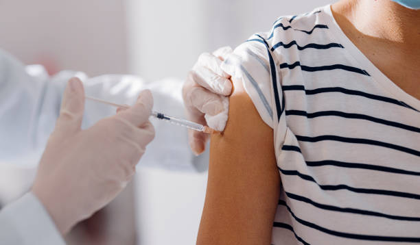 istock Staying Healthy: Nurse Injecting a Patient With a Vaccine in Her Arm 1305839556