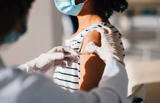 istock Immunisation Process: Nurse Injecting a Patient With a Jab in Her Arm 1305839563