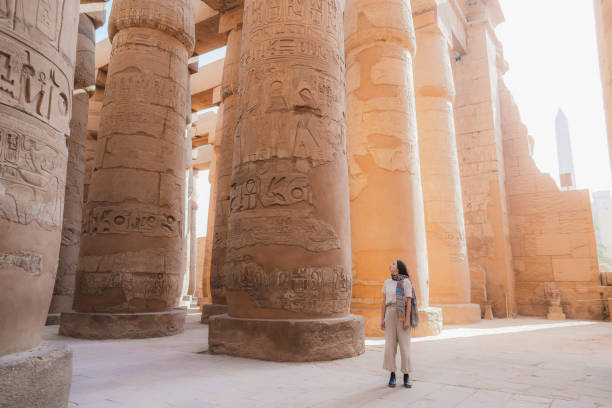 mujer caminando en el antiguo templo egipcio en luxor - egypt egyptian culture column ancient egyptian culture fotografías e imágenes de stock