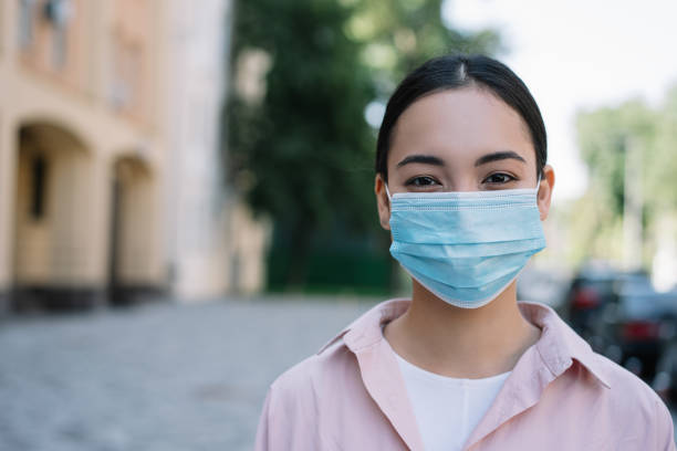 istock Pensive asian doctor wearing protective face mask 1305842894