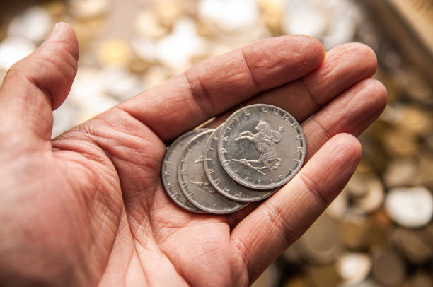 istock Showing Old Coins by a Man 1305843112