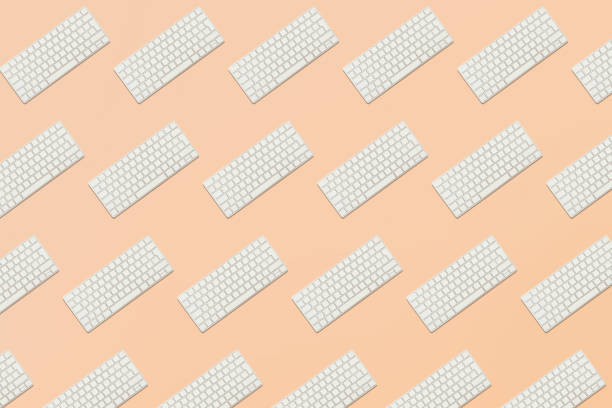 Seamless pattern from keyboard in balance on pink background stock photo