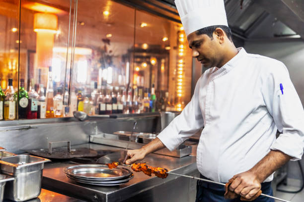 Chef platting the freshly grilled Chicken Tikka Professional Indian Chef working at a gourmet restaurant masala stock pictures, royalty-free photos & images