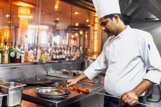 Professional Indian Chef working at a gourmet restaurant
