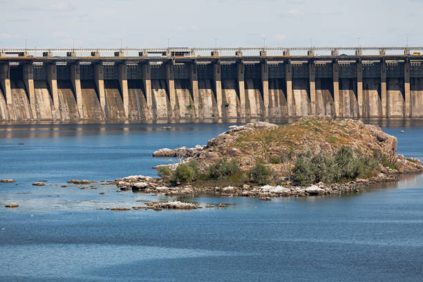 istock Industrial landscape. Powerful concrete dam blocks river 1305845358