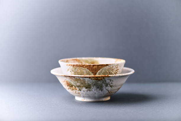 istock Traditional ceramic bowls on paper background. Soft focus. Copy space. 1305845379