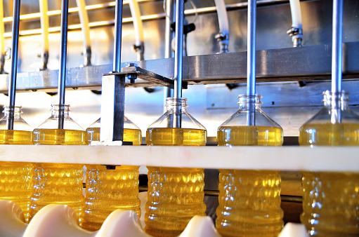 Sunflower oil. Factory line of production and filling of refined oil from sunflower seeds. Factory conveyor of food industry