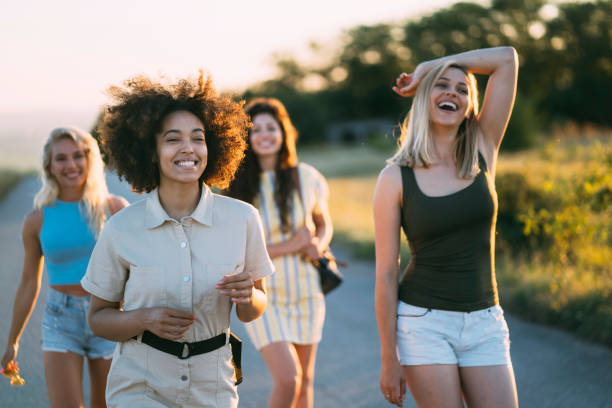 istock Four friends walking on a country road 1305846510