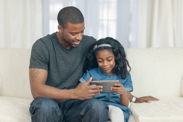 istock Watching A Video With Dad Stock Photo 1305846950