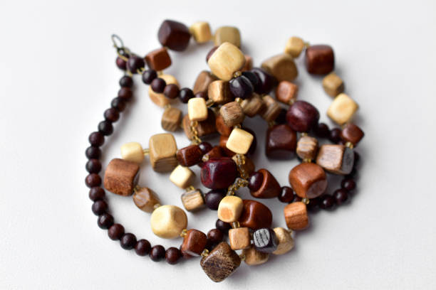 istock Beautiful wooden beads on a white background 1305846993