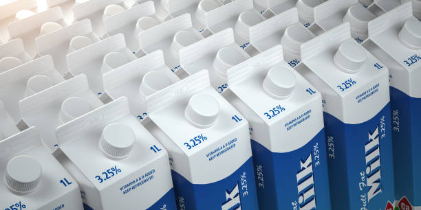 many white boxes or packs of mil in a row - milk industry milk bottle factory imagens e fotografias de stock