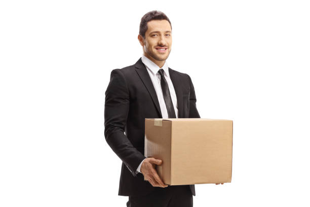 istock Professional man in a suit holding a cardboard box 1305849262