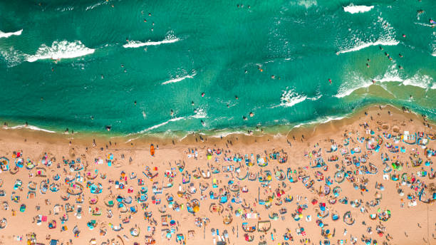 Crowded beach at Baltic Sea. Tourism in Poland. Aerial view Crowded beach at Baltic Sea in summer. Tourism in Poland. Aerial view of nature baltic sea people stock pictures, royalty-free photos & images