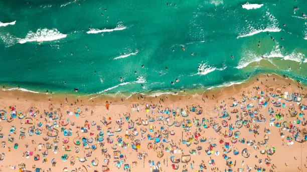 Crowded beach at Baltic Sea in summer. Tourism in Poland. Aerial view of nature