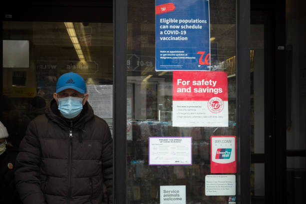 New York during the COVID-19 emergency. Queens, New York. March 04, 2021. The entranced of a Walgreens pharmacy with a sign advertising Covid-19 availability for those eligible. walgreens stock pictures, royalty-free photos & images