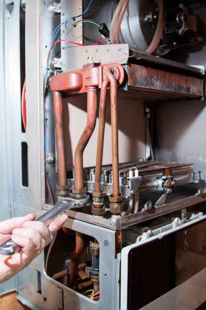 istock worker unscrews the nuts to remove the heat exchanger from the g 1305853792