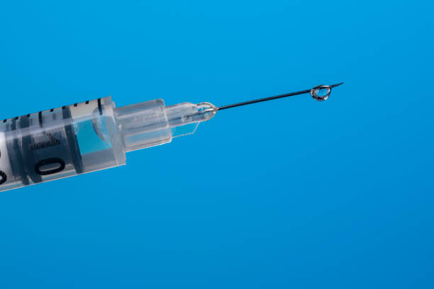 istock A drop of vaccine on a syringe needle close-up. 1305854855