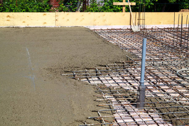 istock pouring concrete into prepared place with reinforced metal frame 1305859109